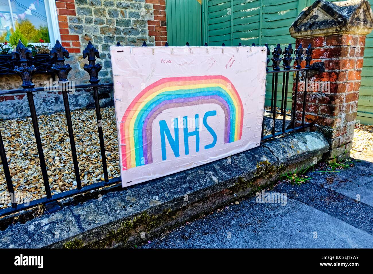 Warminster, Wiltshire UK - April 23 2020: A Rainbow of Hope picture praising the NHS and Key-Workers fighting the Coronavirus, tied onto railings Stock Photo