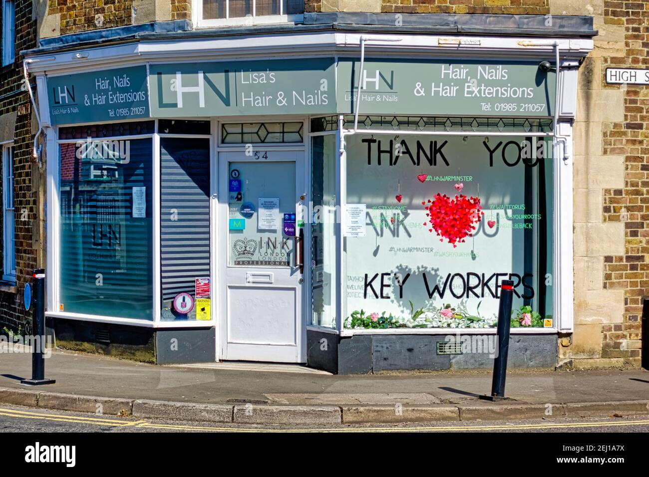 Warminster, Wiltshire  UK - April 15 2020: A window at the LHN Professional Hair & Nail Care Salon decorated to pay tribute to the NHS and Key workers Stock Photo