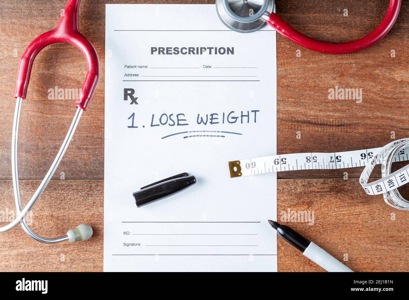 https://c8.alamy.com/comp/2EJ1B1N/flat-lay-image-of-a-physician-desk-with-a-stethoscope-a-pen-a-tape-measure-and-a-prescription-that-says-lose-weight-getting-in-shape-doctor-recom-2EJ1B1N.jpg