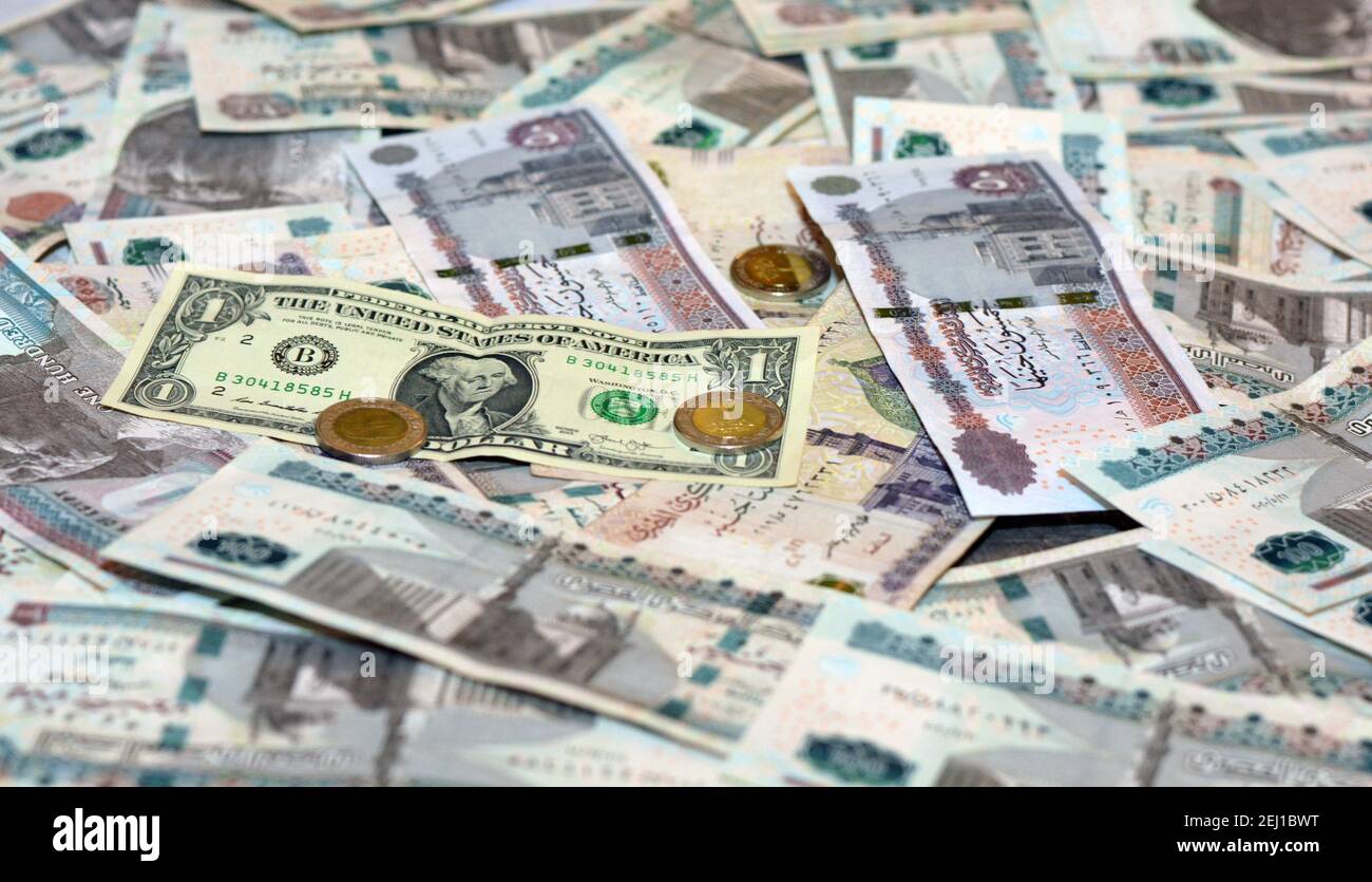 Egypt national currency with USA dollar banknote backdrop. Egyptian