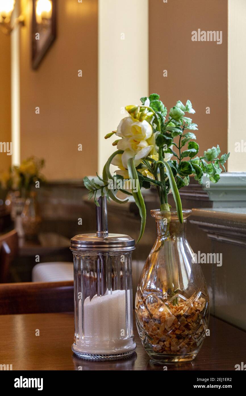 Yellow flowers on a vase in a cafe Stock Photo Alamy