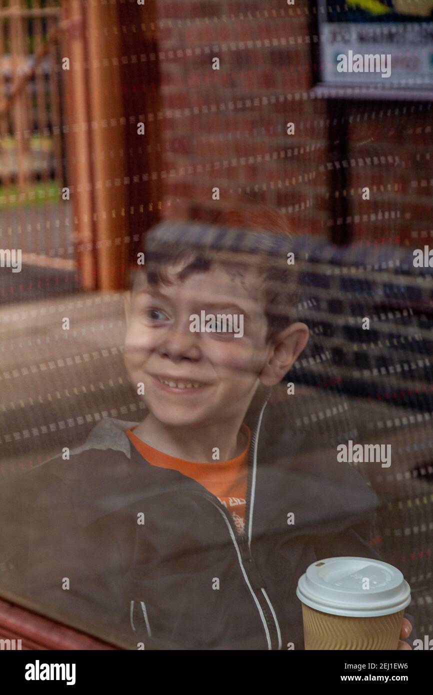 Boy looking through a train's window Stock Photo