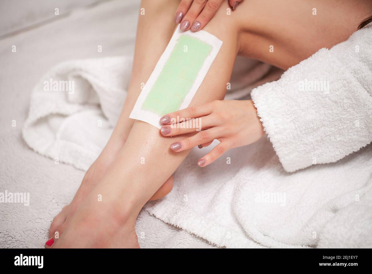 Young woman in Spa getting legs waxed for hair removal Stock Photo Alamy