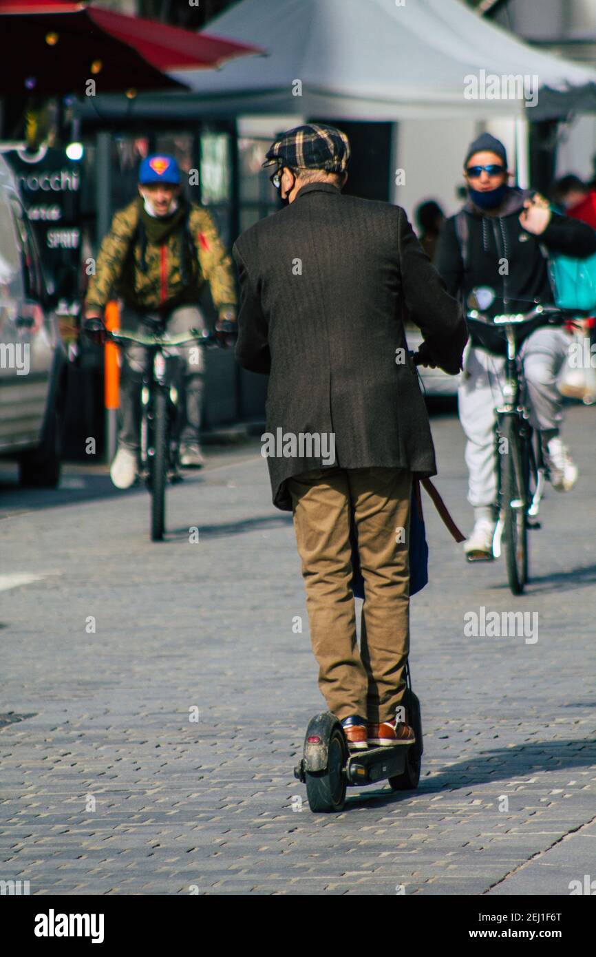 Reims France February 20, 2021 People rolling with an electric scooter in the streets of Reims, operating with a small utility internal combustion eng Stock Photo