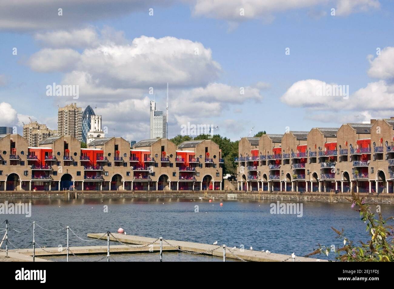 The dockland redevelopment at Shadwell Basin in East London with towers from the City of London financial district in the distance. Stock Photo