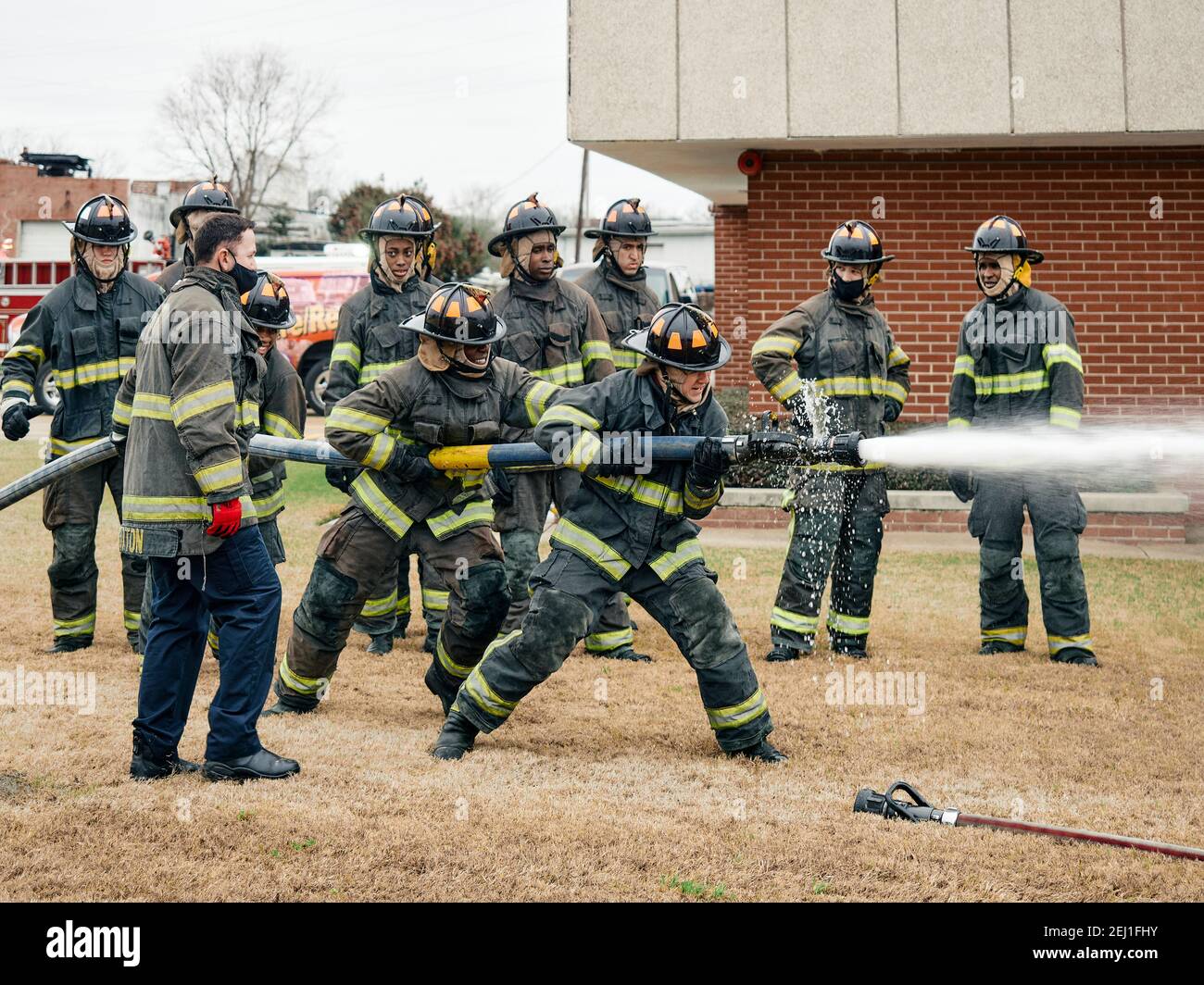 Firefighter trainees going through firefighter training with fire hoses at the fire academy in Montgomery Alabama, USA. Stock Photo