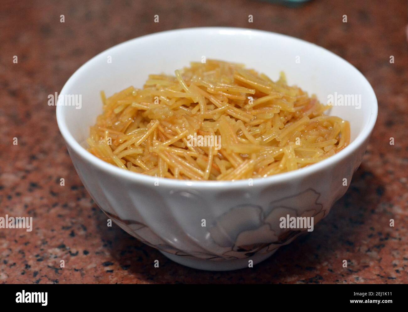 Browned in Butter sweet Egyptian vermicelli cooked with water and sugar served in a white dish,. traditional Egyptian dessert in late lunch and early Stock Photo