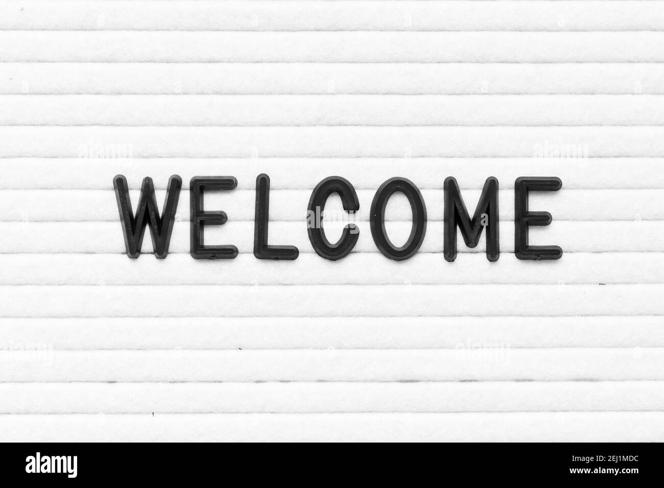 Black color letter in word welcome on white felt board background Stock ...