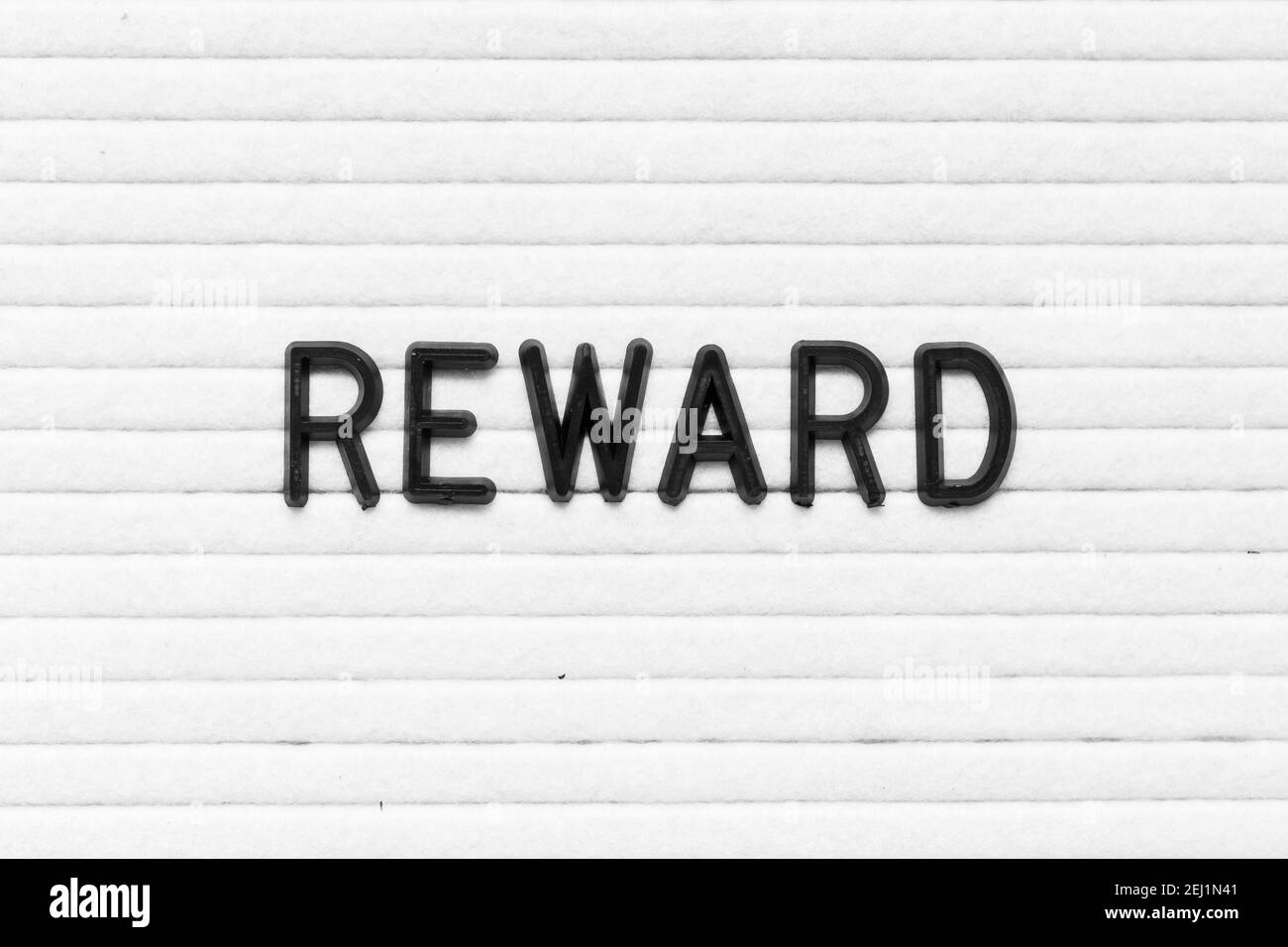 Black color letter in word reward on white felt board background Stock Photo