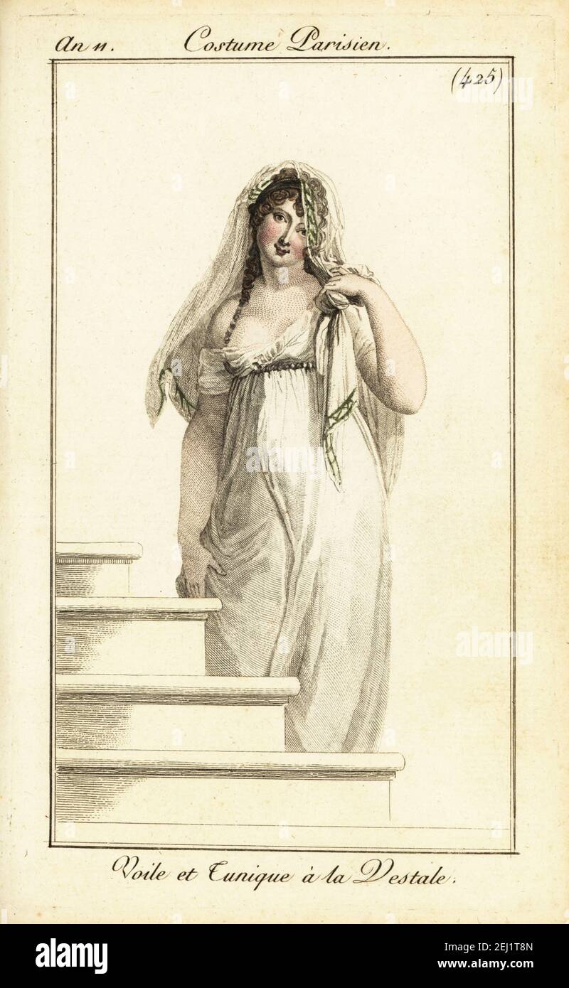 Merveilleuse in lace veil and tunic dress. This early Empire style was named after the Vestal Virgins. Voile et Tunique à la Vestale. Handcoloured copperplate engraving from Pierre de la Mesangere’s Journal des Dames et des Modes, Magazine of Women and Fashion, Paris, An 11, November, 1802. Illustrations by Carle Vernet, Jean-Francois Bosio, Dominique Bosio and Philibert Louis Debucourt, engraved by Pierre-Charles Baquoy. Stock Photo