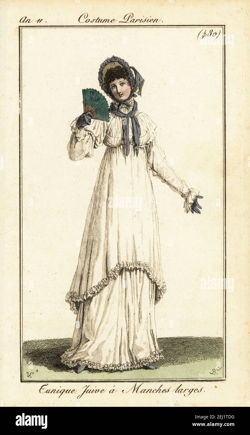 Woman in a long dress with calf-length tunic in same fabric, wide sleeves, bonnet, fichu, gloves and fan. Tunique Juive à Manches larges. Handcoloured copperplate engraving by Pierre-Charles Baquoy after Carle Vernet from Pierre de la Mesangere’s Journal des Dames et des Modes, Magazine of Women and Fashion, Paris, An 11, 1803. Stock Photo