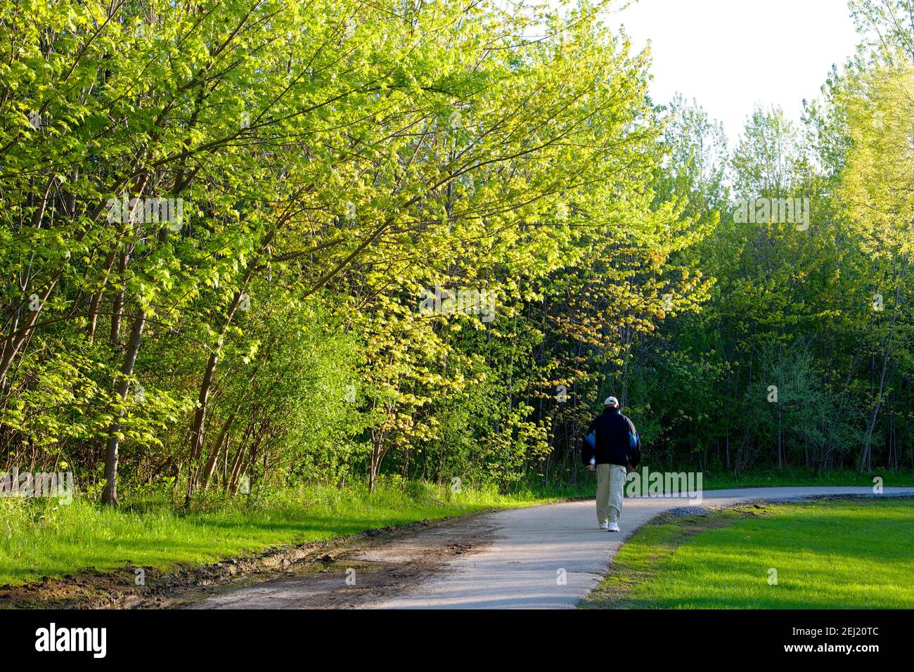 Toronto, Ontario / Canada - 05-22-2014: Loney man walking in the public park in springtime. Stock Photo
