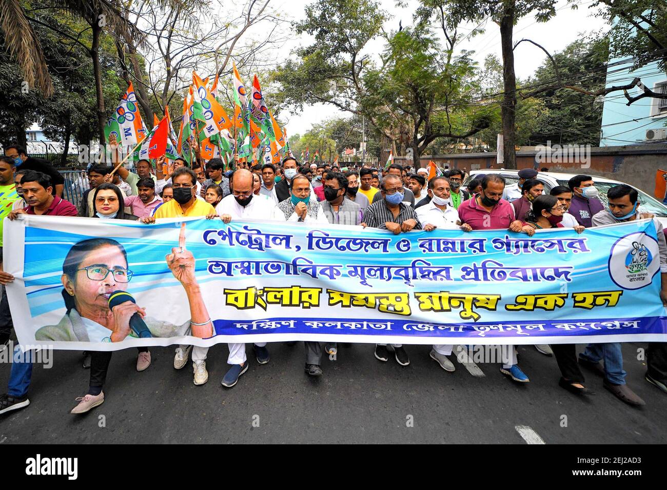 Protestors holding a large banner expressing their opinion during the demonstration.All India Trinamool Congress protest against the regular price hike on Petrol & Diesel in front of an Indian Oil Petrol Pump. Stock Photo