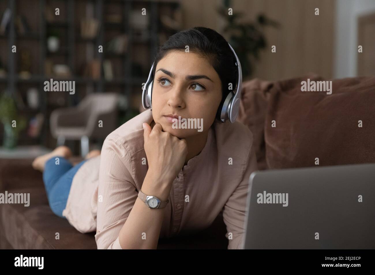 Pensive Indian woman look in distance making plans Stock Photo - Alamy