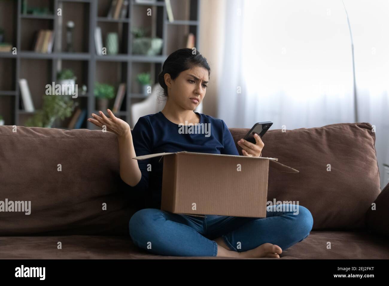 Unhappy Indian female buyer frustrated by wrong order Stock Photo