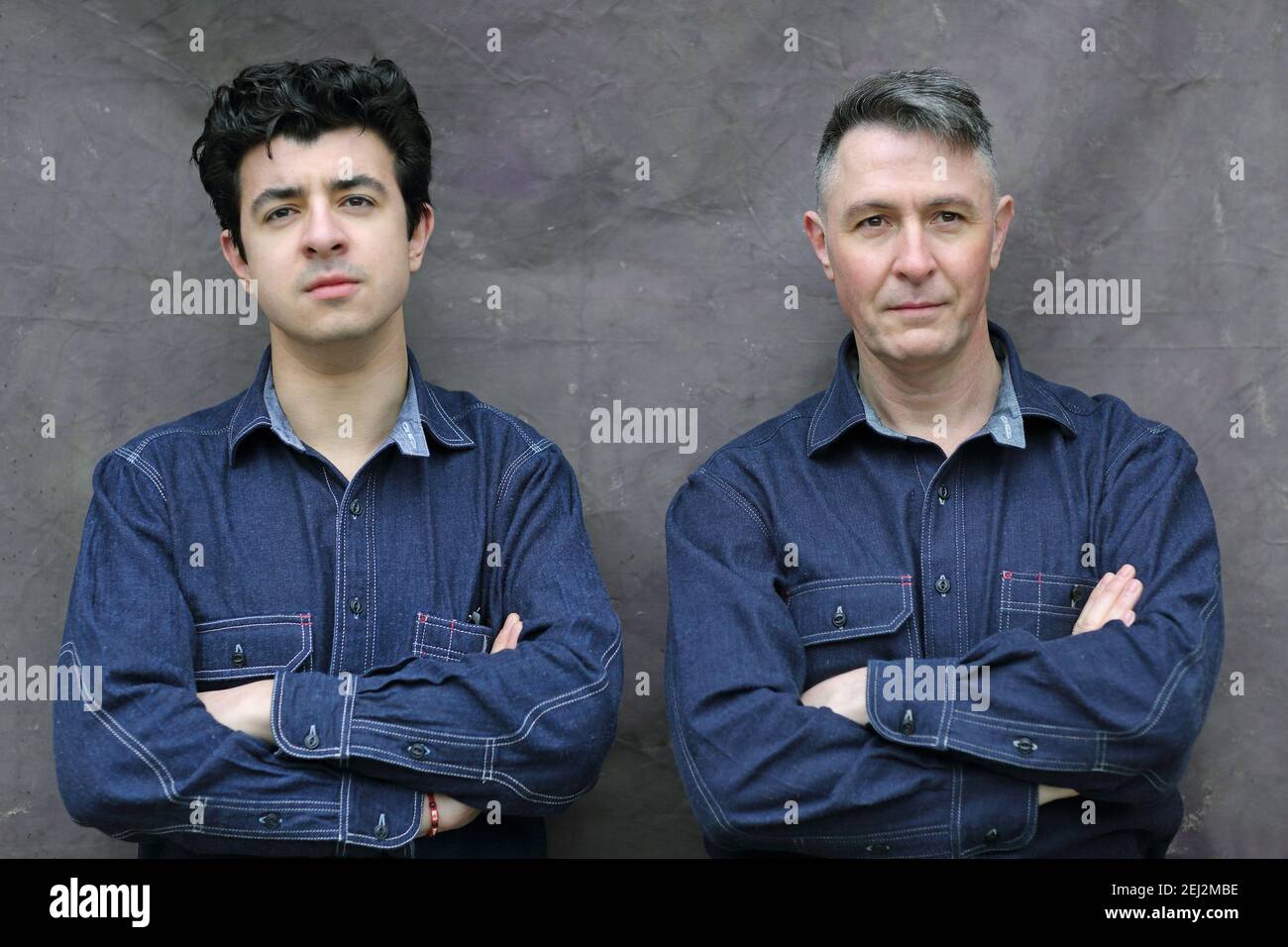 Father and son wearing same jeans shirts. Stock Photo