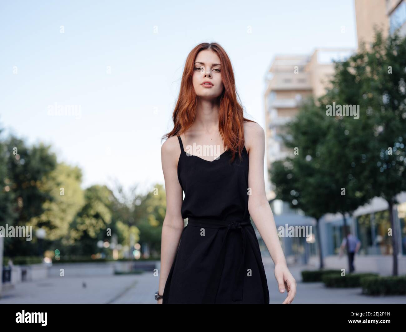 Beautiful woman in black dress walks back hi-res stock photography and ...