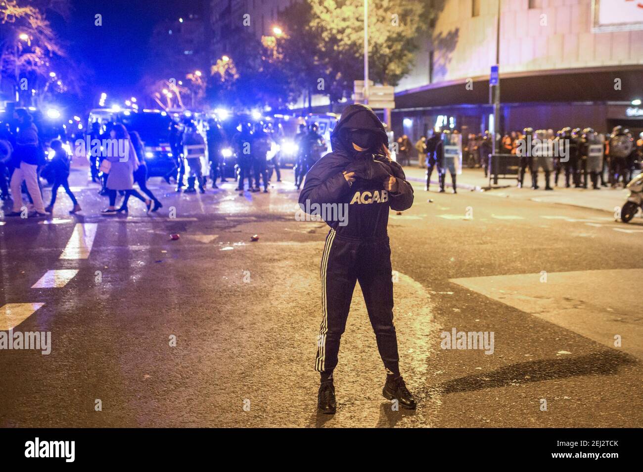 Barcelona, Spain. 20th Feb, 2021. A protester seen in front of the police showing her shirt saying ACAB (All cops are bastards) during the demonstration.Protesters demonstrated for the Fifth day after rapper Pablo Hasél was detained for insulting the Spanish Royal Family in his songs and other acts of violence. Credit: SOPA Images Limited/Alamy Live News Stock Photo