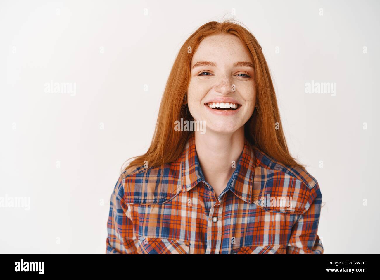 Girl student with ginger hair and blue eyes smiling happy at camera