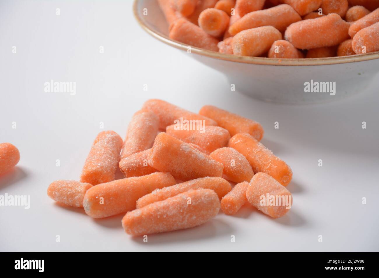 Small frozen carrots pieces. Healthy food. Frozen vegetables Stock