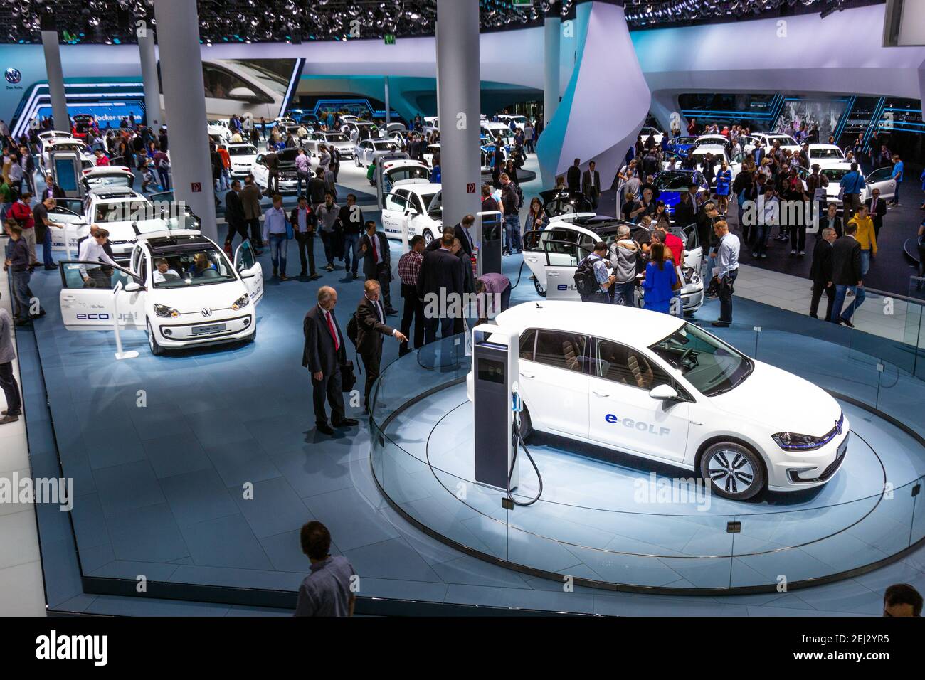FRANKFURT, GERMANY - SEP 13, 2013: Trade show visitors at the Volkswagen stand with the new cars showcased at the Frankfurt IAA Motor Show. Stock Photo