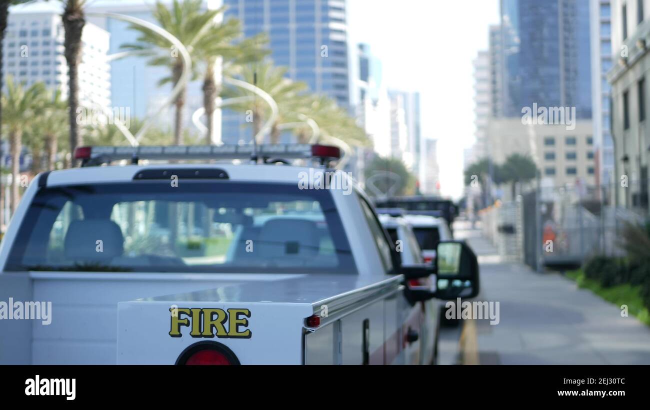 SAN DIEGO, CALIFORNIA USA - 15 JAN 2020: Fire department trucks and Sheriff's car with emergency sirens parked on Broadway. Firefighters vehicles in d Stock Photo