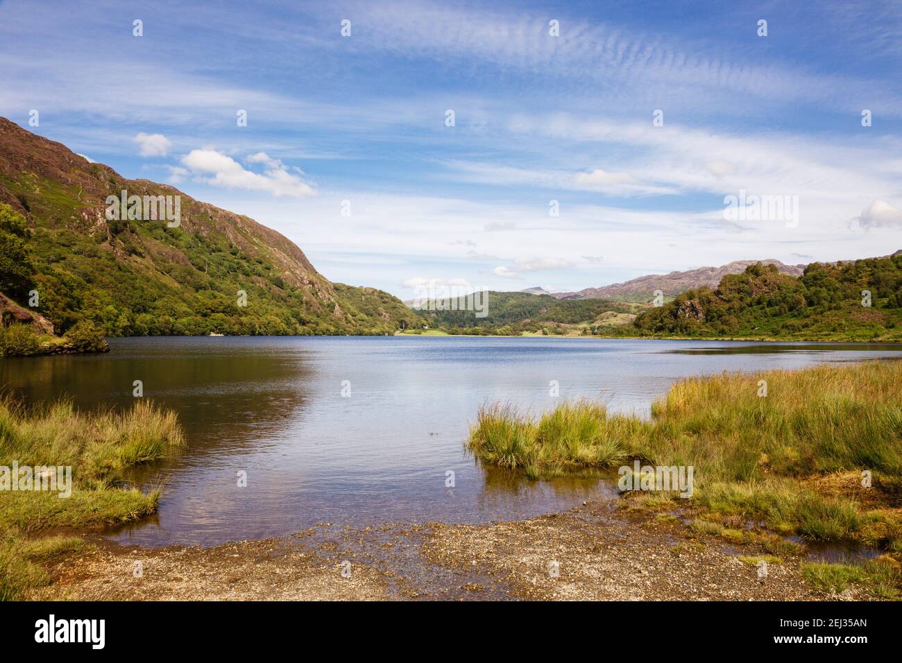 View of scenic Llyn Dinas lake in Snowdonia National Park mountains in summer. Bethania Gwynedd North Wales UK Britain Stock Photo