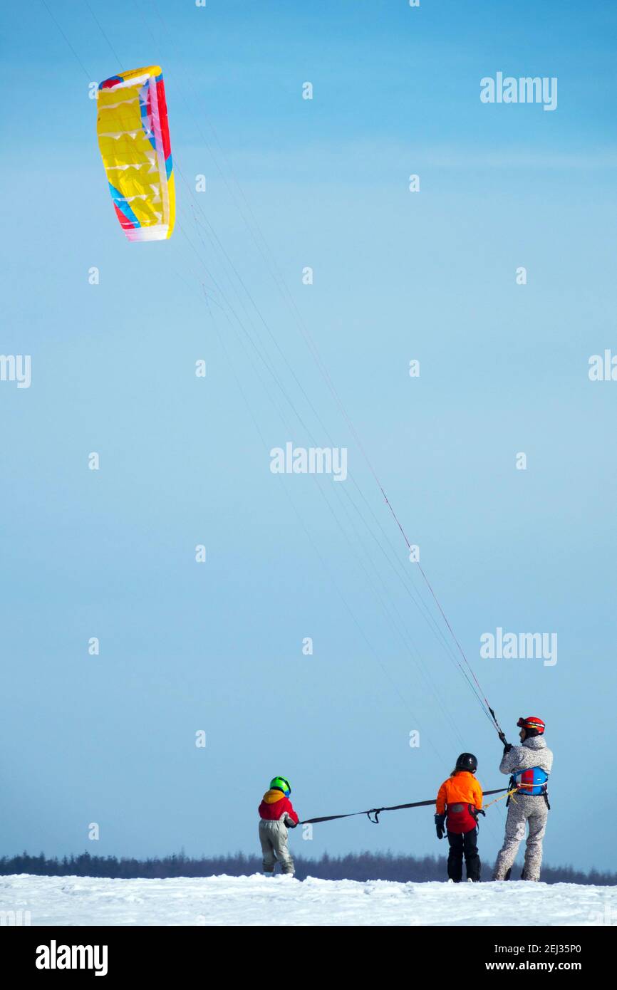 Family snow kiting, father and two children, winter lifestyle sports snowkiter, family sports Stock Photo