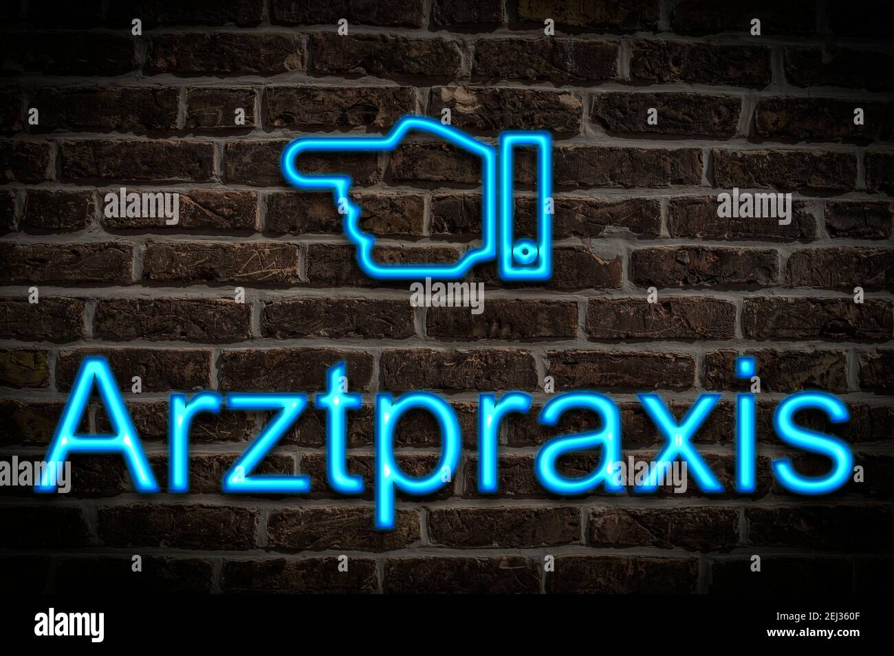 Detail photo of a neon sign on a wall with the inscription Arztpraxis Stock Photo