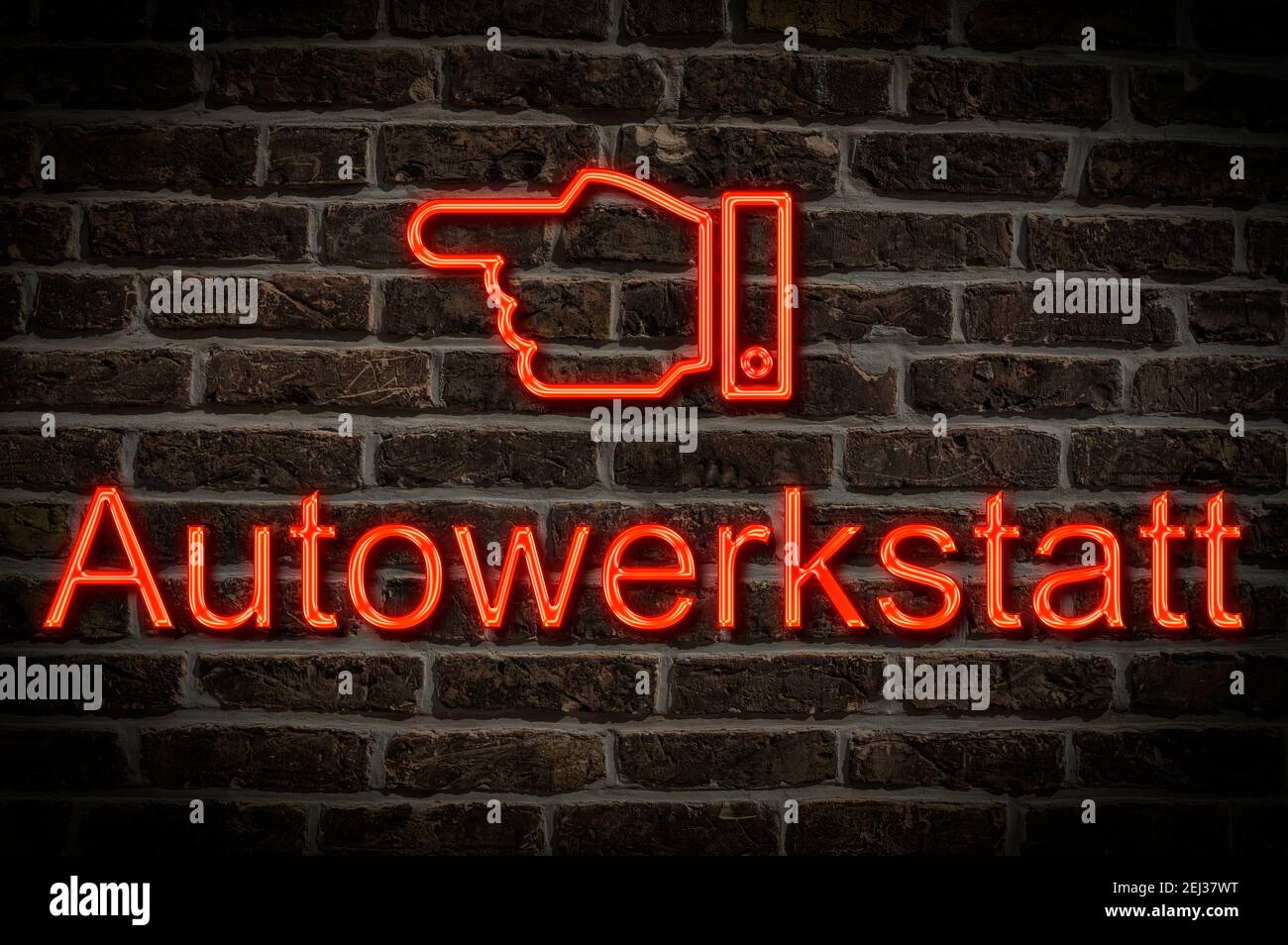Detail photo of a neon sign on a wall with the inscription Autowerkstatt Stock Photo