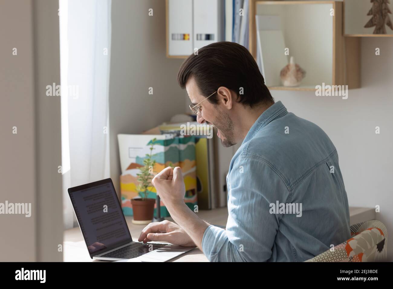 Excited millennial man celebrate hi-res stock photography and images ...