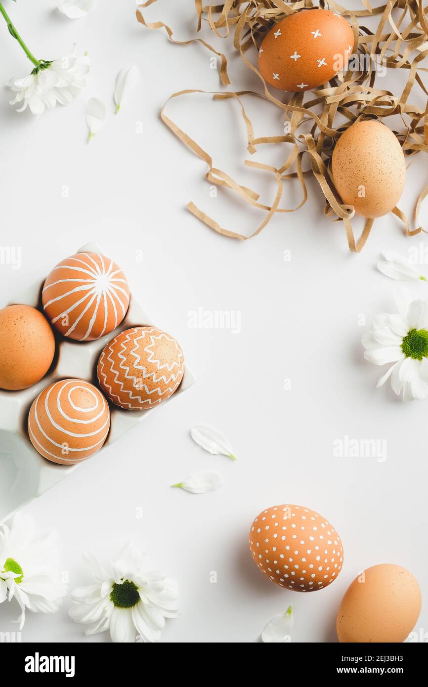 Happy Easter flat lay composition with Easter eggs in straw and spring ...
