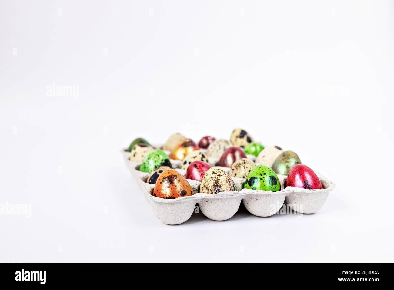 Colored quail Easter eggs in a box on the white background. Easter holiday concept. Stock Photo