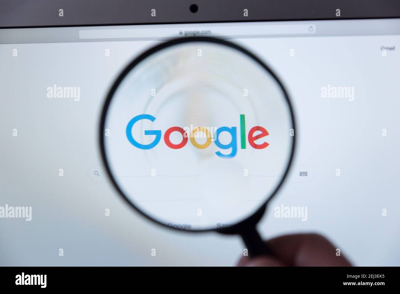 Wroclaw, Poland - DEC 2, 2020: Google logo through a magnifying glass. Google is most popular web search engine Stock Photo