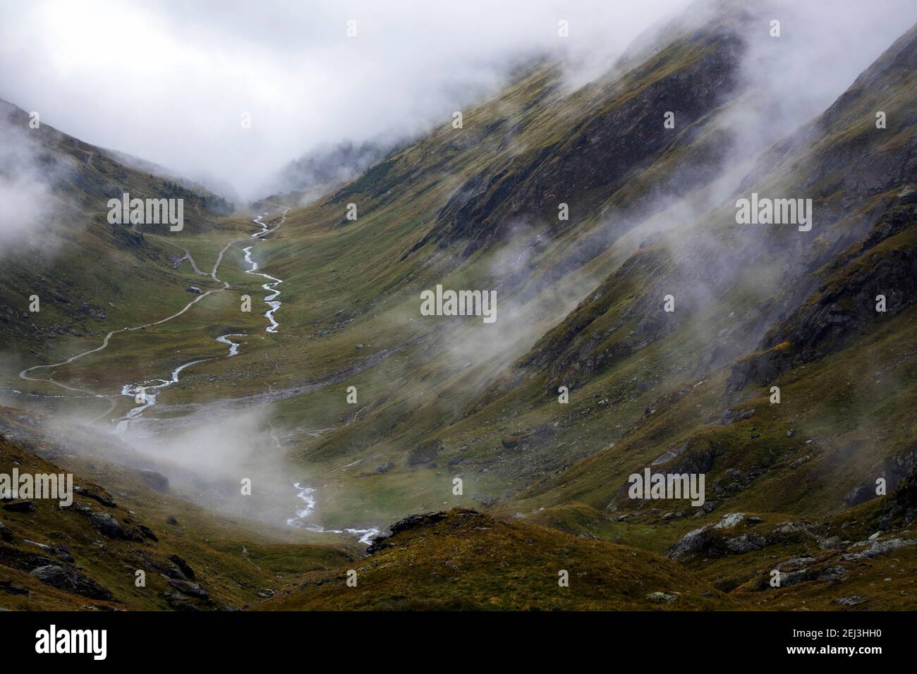 Timmel valley (Timmeltal). Alpine torrent. Evocative clouds. Venediger group. Virgental. Austrian Alps. Europe. Stock Photo