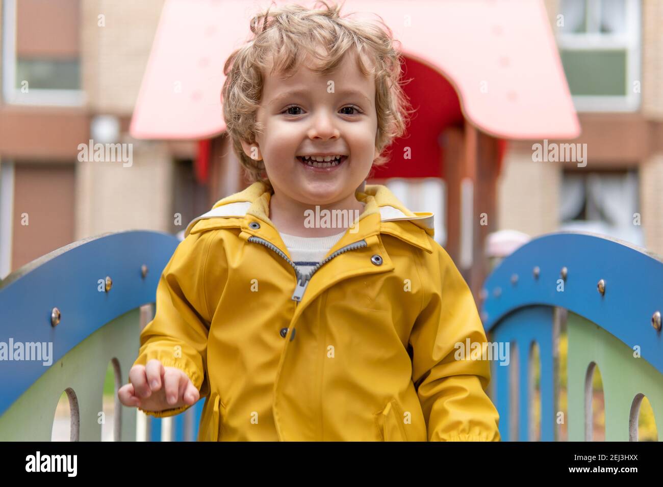 Two and a half year old boy happy and smiling playing in a playground