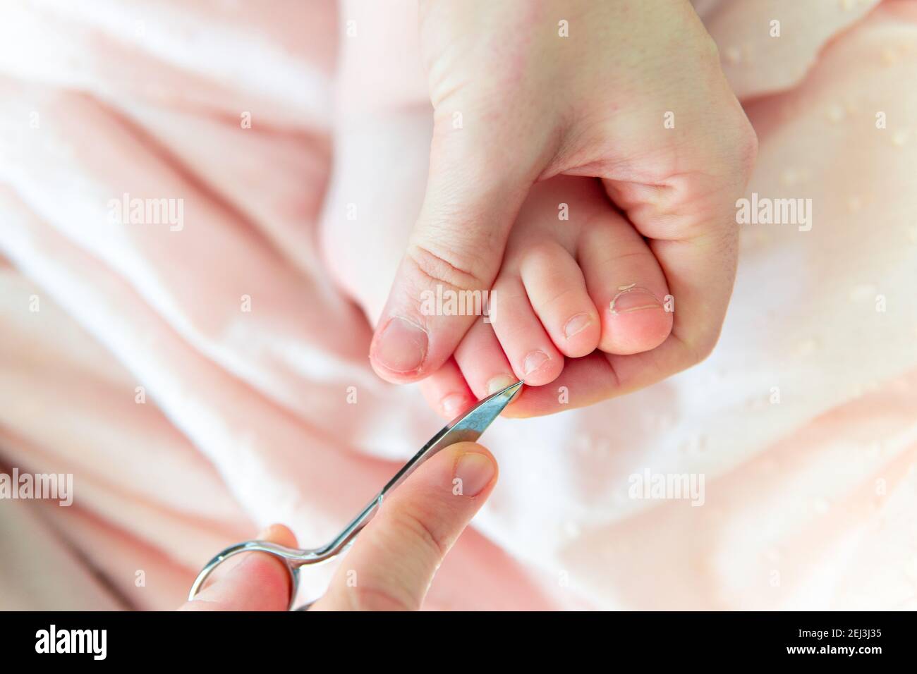 Woman's hands with scissors for cutting nails counting the toenails of baby six months. baby care concept Stock Photo - Alamy Woman's hands with scissors for cutting nails counting the toenails of baby six months. baby care concept Stock Photo - Alamy