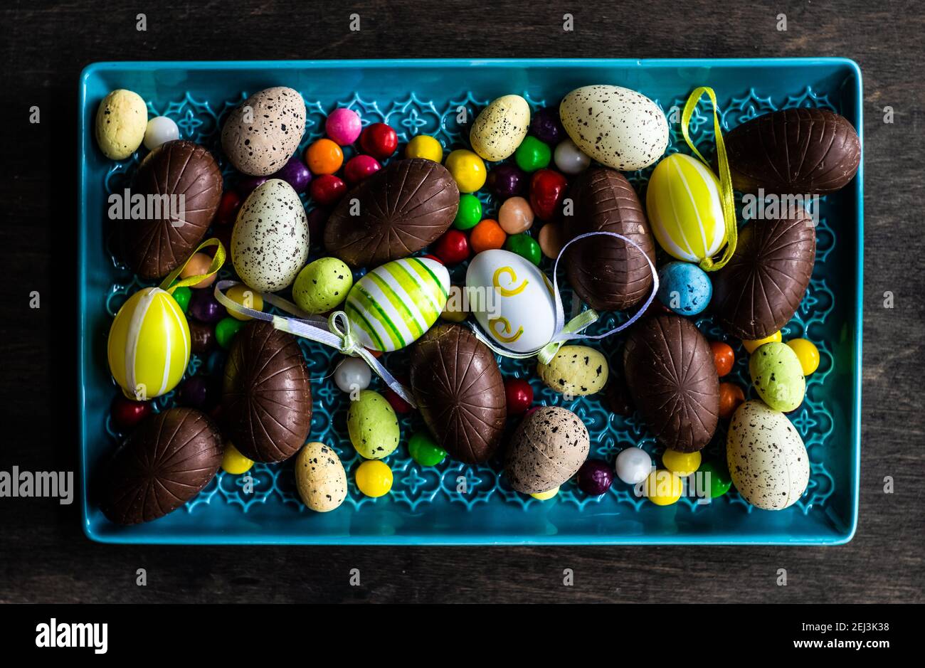 Easter place setting with various chocolate eggs in a bowl Stock Photo