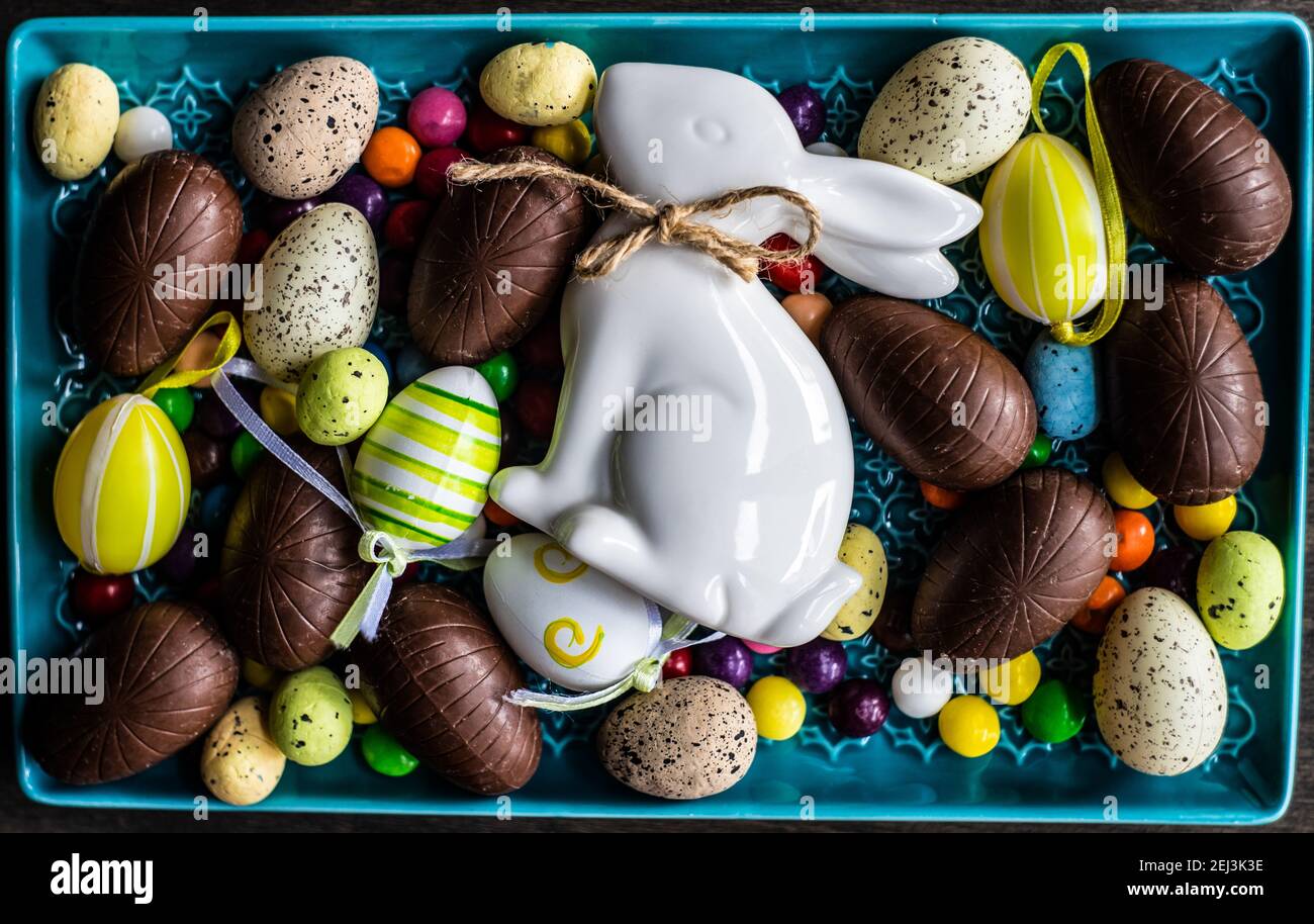 Easter place setting with various chocolate eggs in a bowl Stock Photo