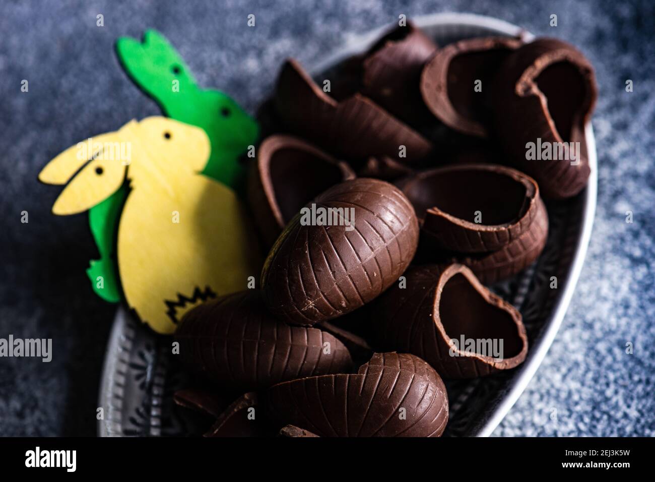 Easter place setting with various chocolate eggs in a bowl Stock Photo