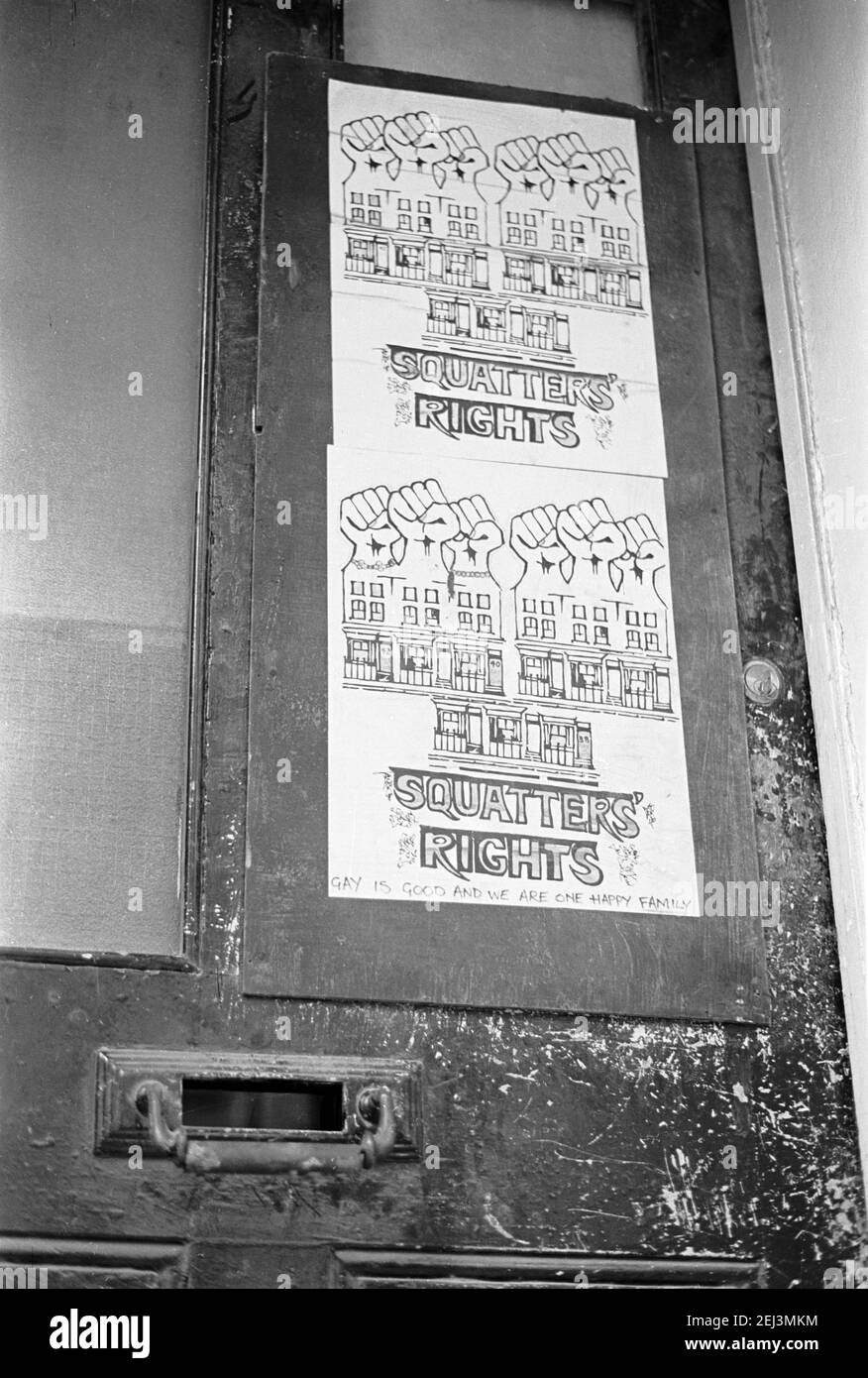 UK, West London, Notting Hill, 1973. Rundown & dilapidated large four-story houses are starting to be restored and redecorated. Posters on the door of a squat say 'Squatters Rights & added is 'gay is good and we are all one happy family', Stock Photo