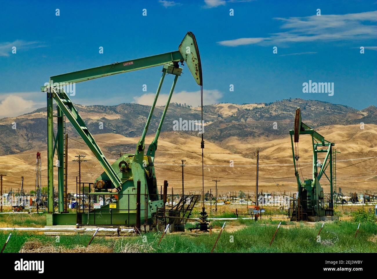 Oil derricks at Coalinga oil and gas field, Derrick Boulevard, Coalinga, California, USA Stock Photo