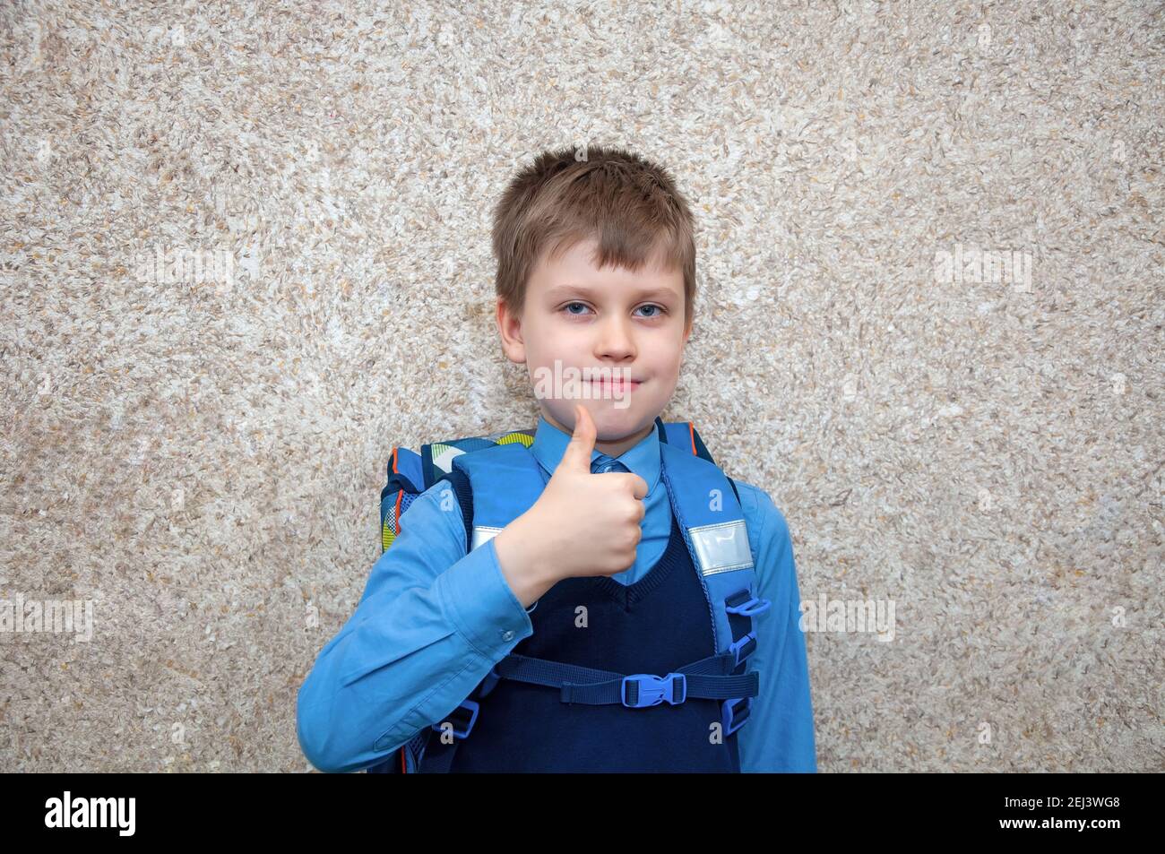 Child with a schoolbag shows the gesture ok. Stock Photo