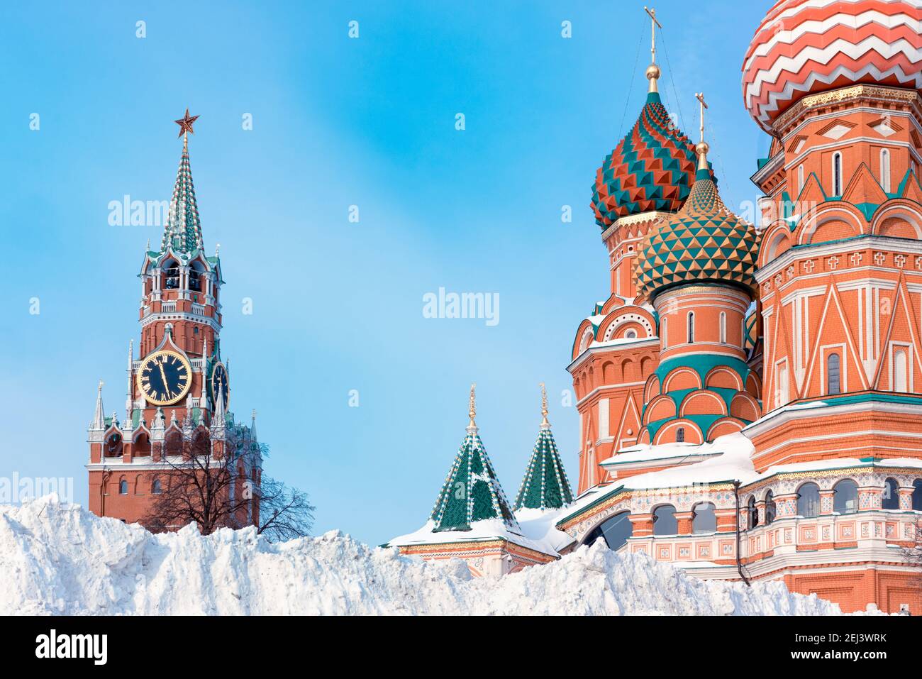 Snow pile near St. Basil's Cathedral and Spasskaya tower, winter in Moscow, Russia. Stock Photo