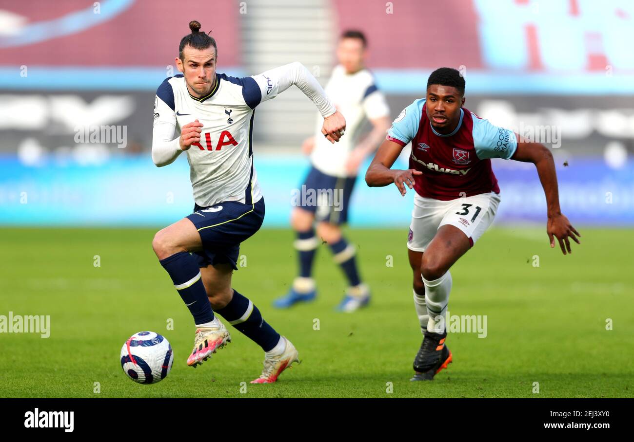 Tottenham Hotspur's Gareth Bale (left) and West Ham United's Ben Johnson  battle for the ball during the Premier League match at the London Stadium,  London. Picture date: Sunday February 21, 2021 Stock