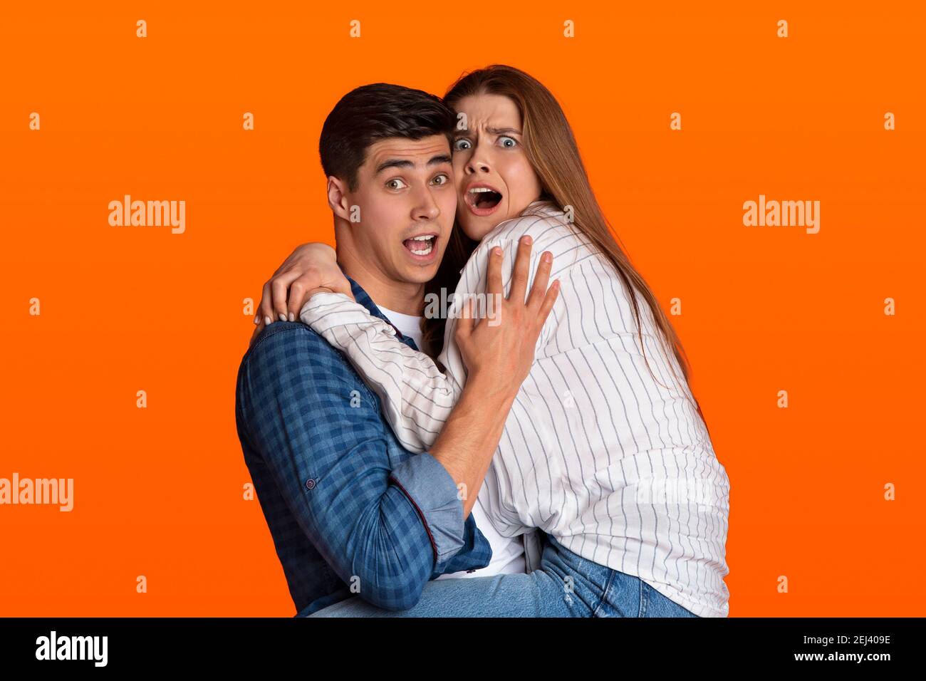 Fright excited scared millennial zoomers woman with open mouth afraid and screams Stock Photo