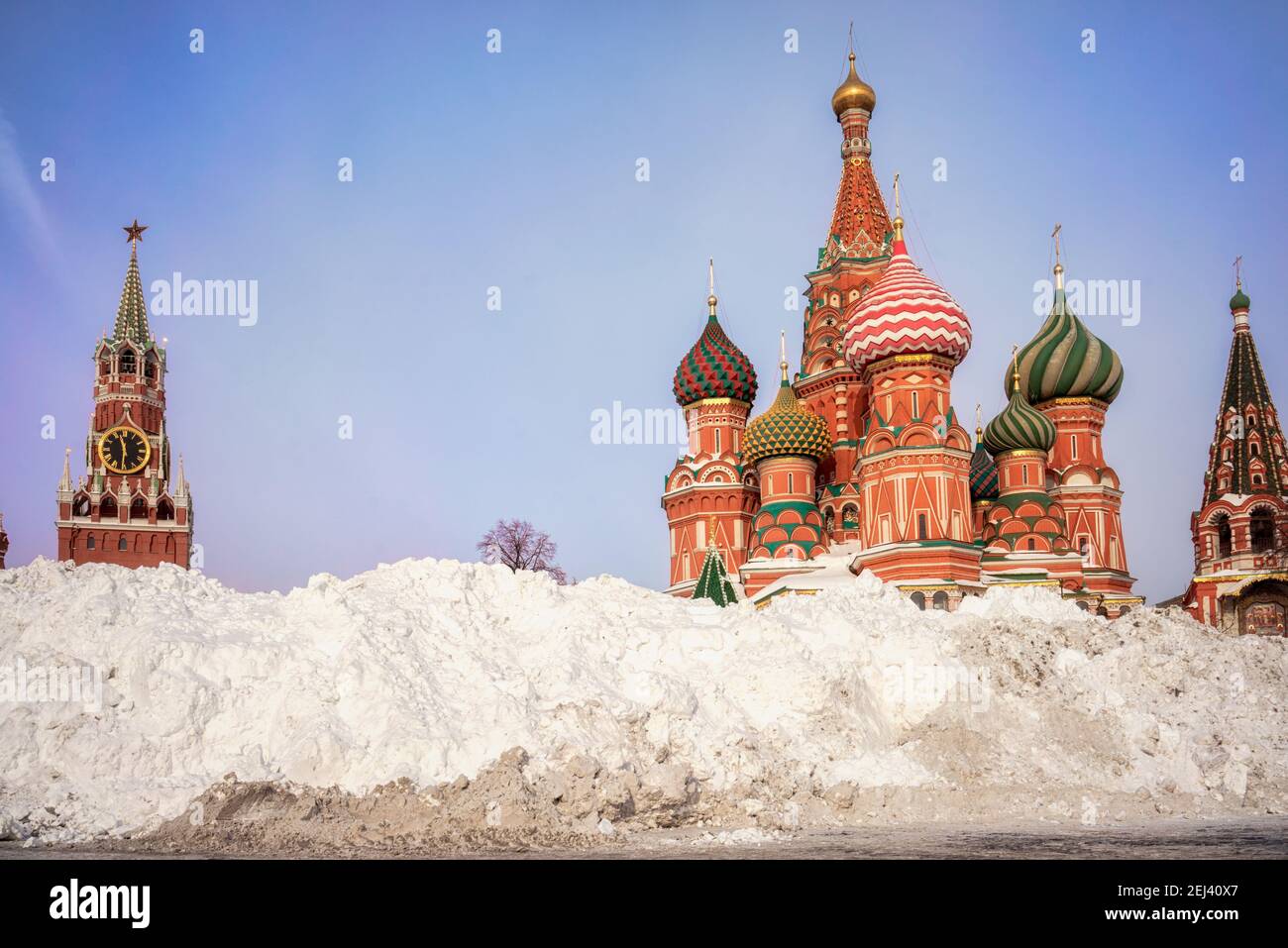 Snow pile near St. Basil's Cathedral and Spasskaya tower. Winter in Moscow, Russia. Stock Photo
