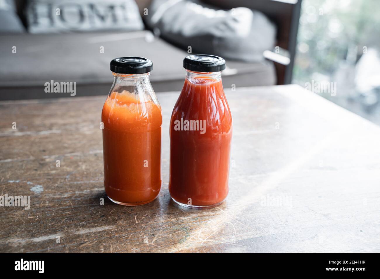 chili sauce and tomato ketchup in a glass bottle on the table Stock Photo Alamy