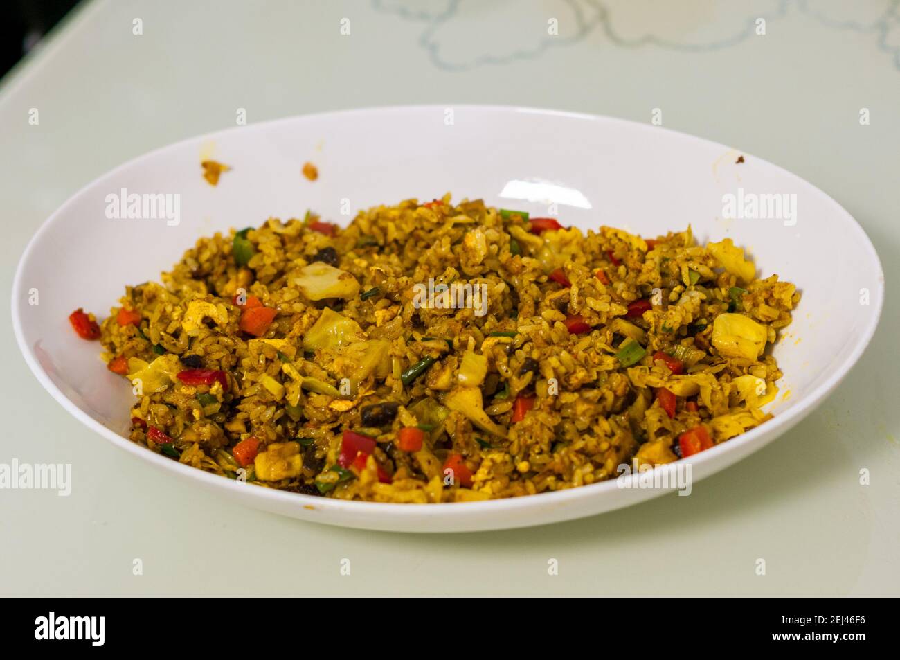 Vegetarian curry fried rice using Omipork ground plant-based meat. Note there is egg in this dish. Stock Photo