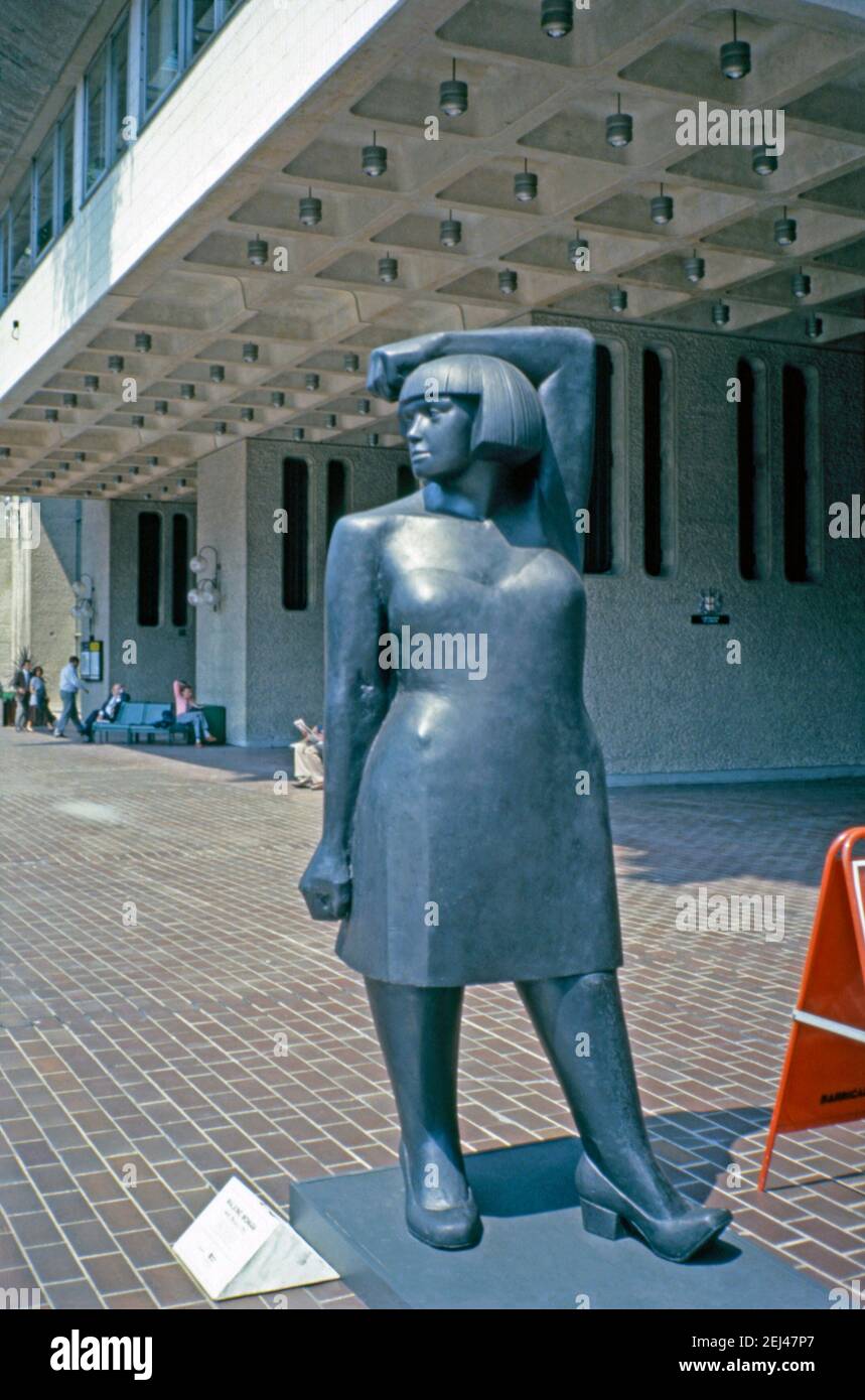 A 1993 bronze sculpture, ‘Waking Woman’, by André Wallace, City of London, London, England, UK 1993. This was part of 1993’s ‘Art in the City’ and was aimed at setting sculpture amongst the green spaces and the distinctive architecture of the City of London. André Wallace (b 1947) is a sculptor and artist working in bronze, stone, translucent resin, and various metals and also produces works on paper. He often works in a large scale. This image is from an old amateur 35mm colour transparency. Stock Photo